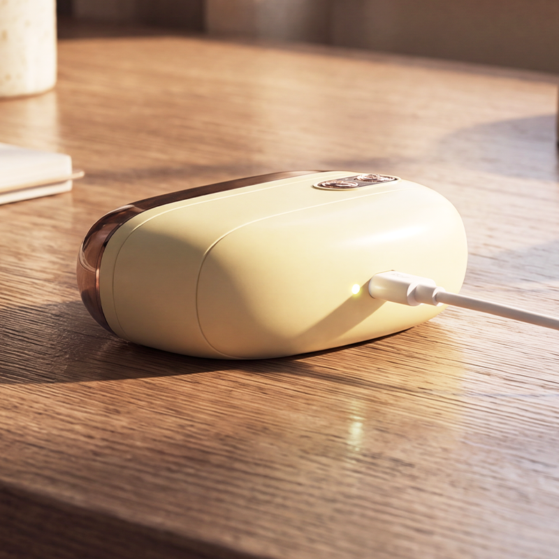 Beige electric nail clipper and smoother on a tabletop