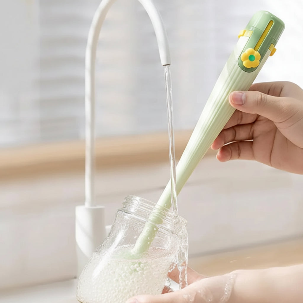 Green brush washing a drinking glass