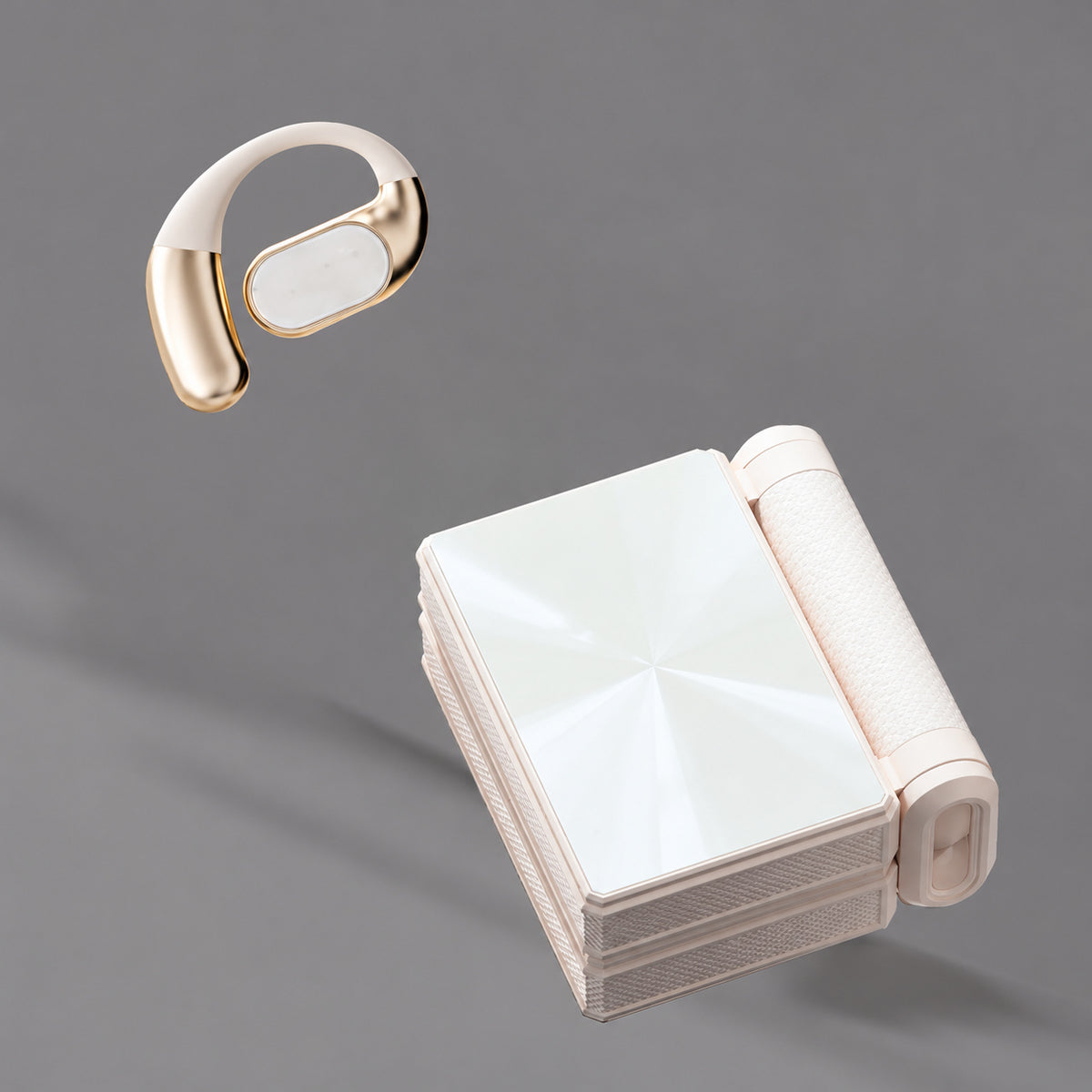 White open-ear earphone beside a white folding charging case