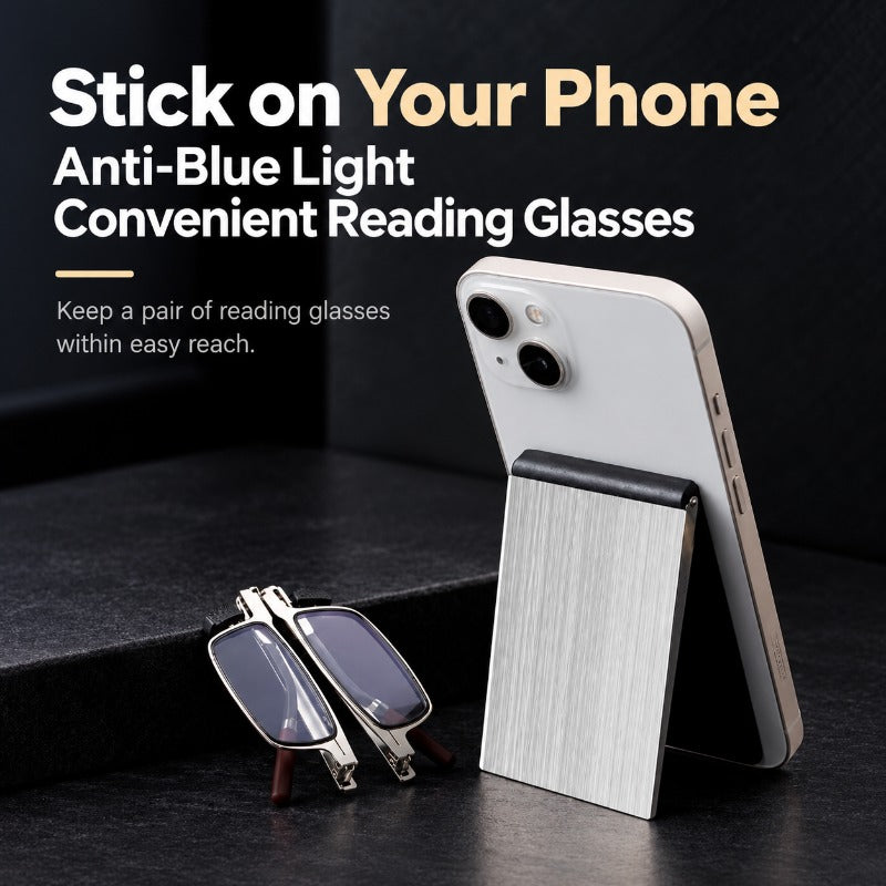 Silver foldable reading glasses beside phone stand case