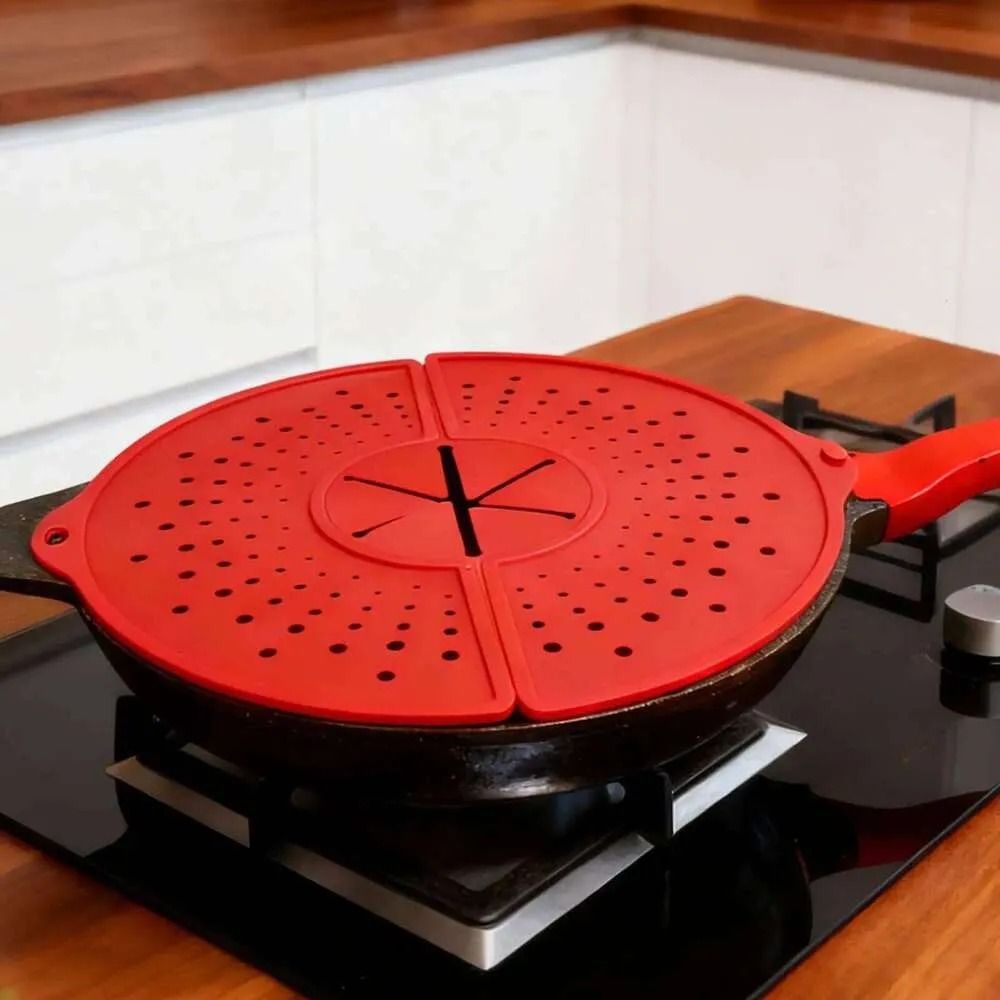 Red guard covering a frying pan