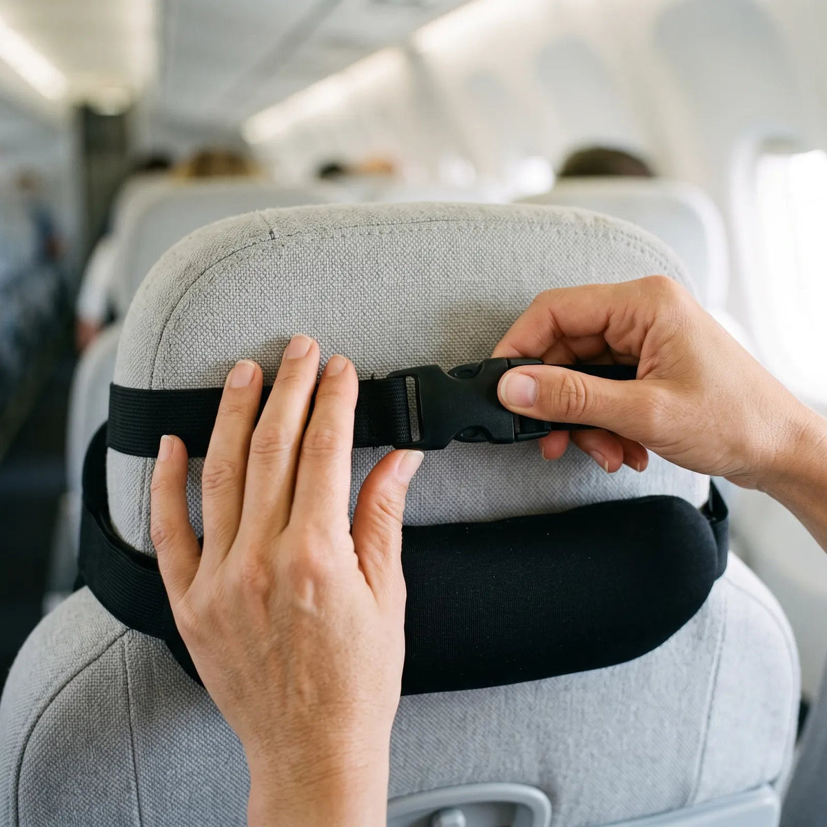 Strap fastening around an airplane headrest